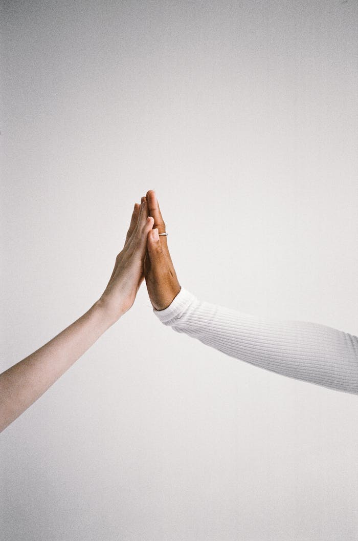 Two hands touching, symbolizing connection and diversity.